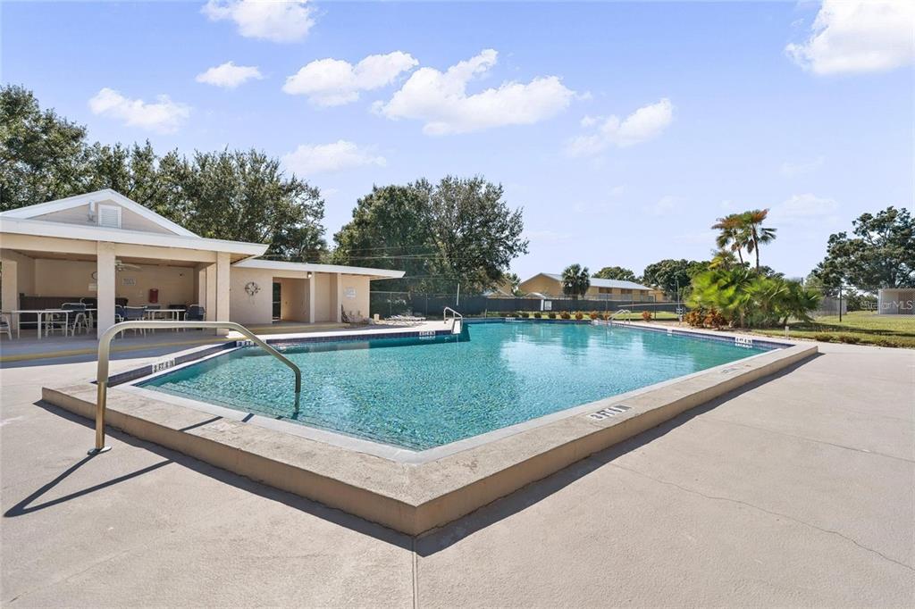 2025 Sylvester Road, Unit N305 Lakeland, FL 33803 - Photo 31 of 34 a view of a house with pool and a yard