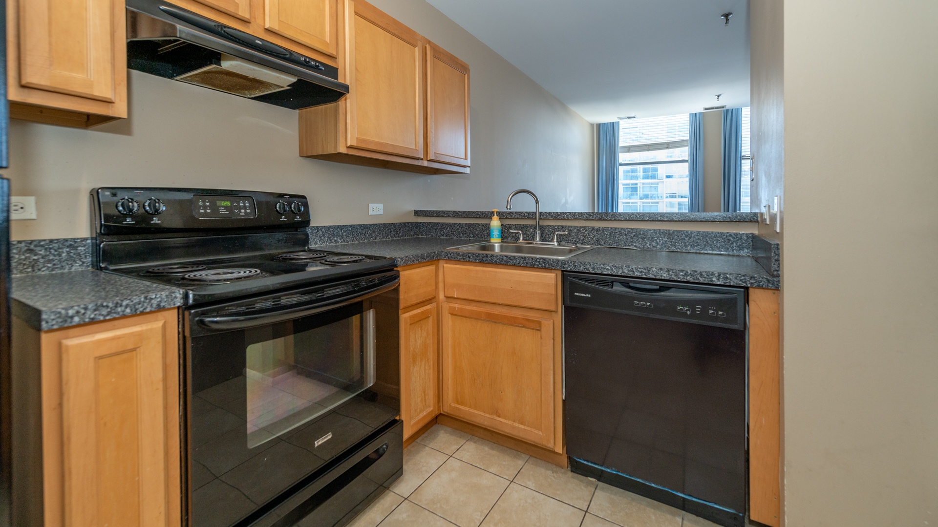 780 South Federal Street, Unit 1106 Chicago, IL 60605 - Photo 3 of 32 a kitchen with stainless steel appliances granite countertop a stove and a microwave