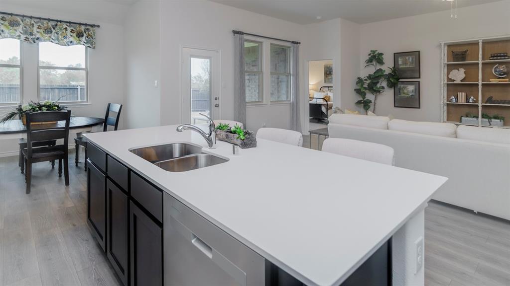 503 Range Road Caddo Mills, TX 75135 - Photo 19 of 19 Kitchen with an island with sink, dishwasher, open floor plan, and light wood finished floors