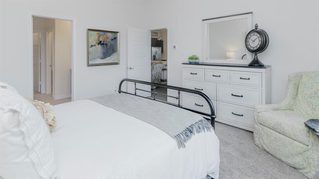 503 Range Road Caddo Mills, TX 75135 - Photo 12 of 19 Bedroom with light carpet and stainless steel fridge with ice dispenser