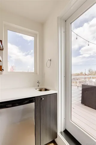 a view of a room with wooden floor and windows