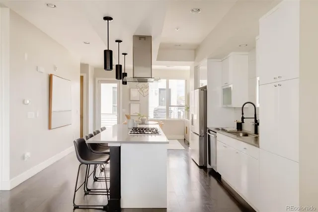 a kitchen with stainless steel appliances a sink stove and refrigerator