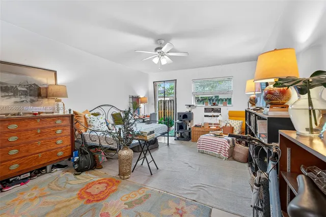 a living room with furniture a rug and a window