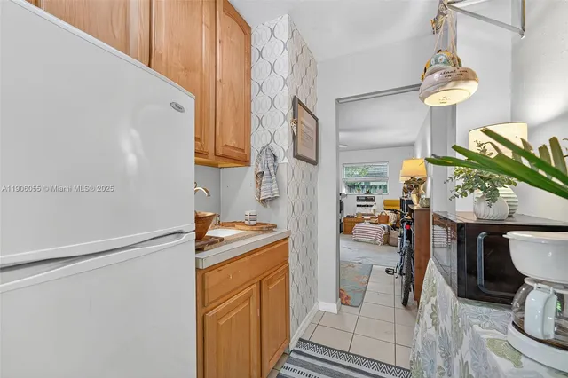 a hallway with a dining table chairs and a stove top oven