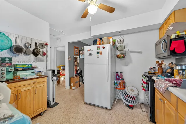 a kitchen with a refrigerator and washer