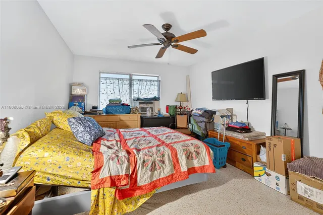 a bedroom with two beds and a flat screen tv