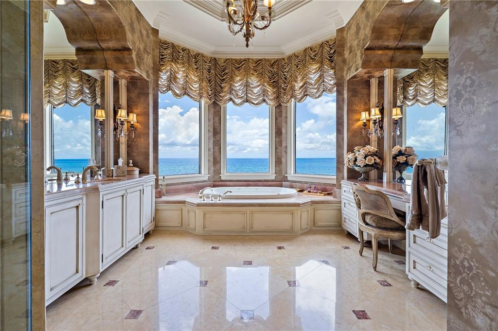 1025 Northeast Doubloon Drive Stuart, FL 34996 - Photo 15 of 69 a very nice looking room with a large window and chandelier