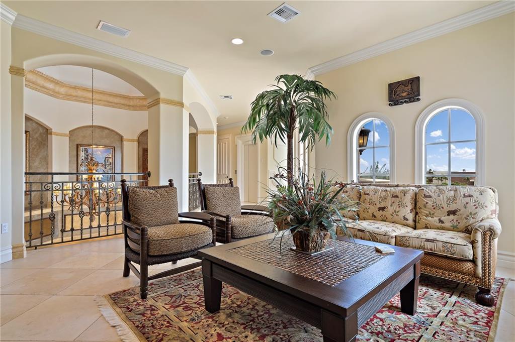1025 Northeast Doubloon Drive Stuart, FL 34996 - Photo 20 of 69 a living room with furniture and a potted plant