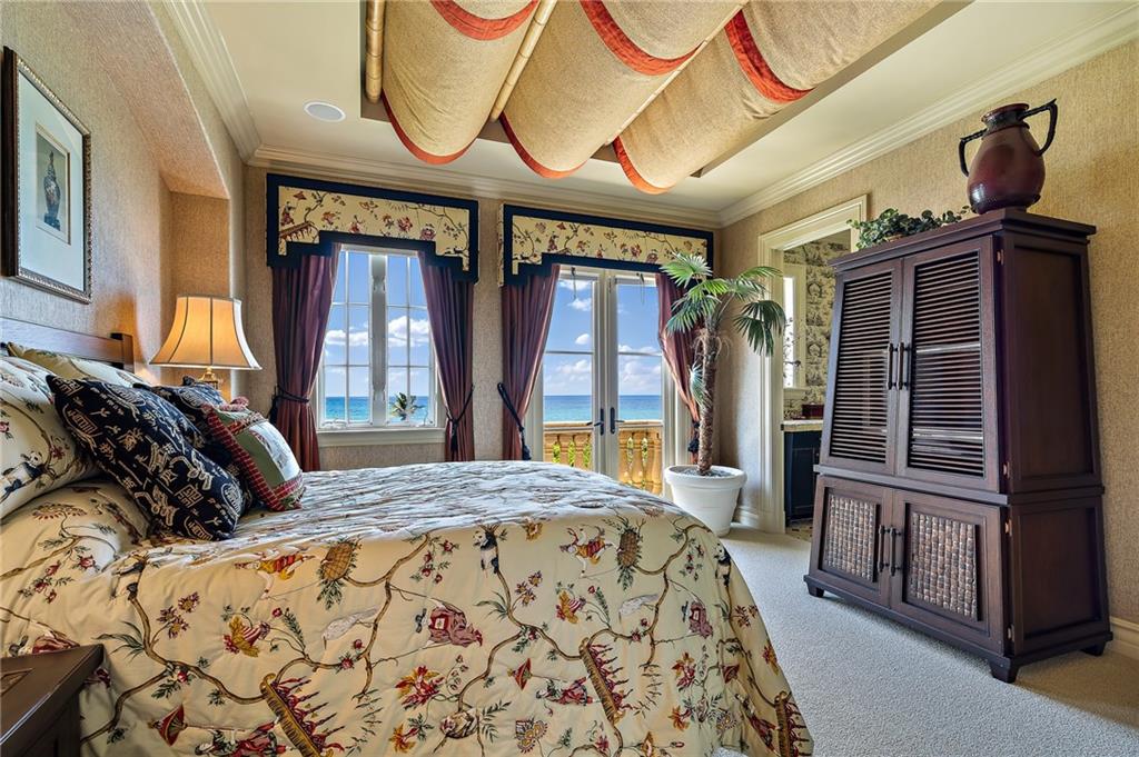 1025 Northeast Doubloon Drive Stuart, FL 34996 - Photo 24 of 69 a bedroom with a bed and a mirror