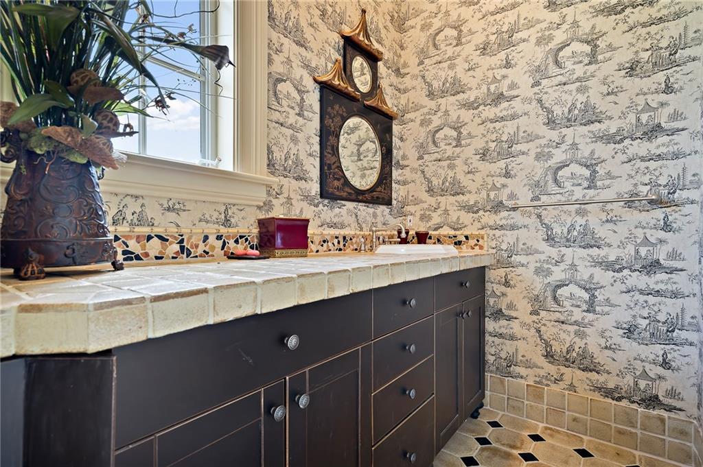 1025 Northeast Doubloon Drive Stuart, FL 34996 - Photo 25 of 69 a bathroom with a sink and a mirror
