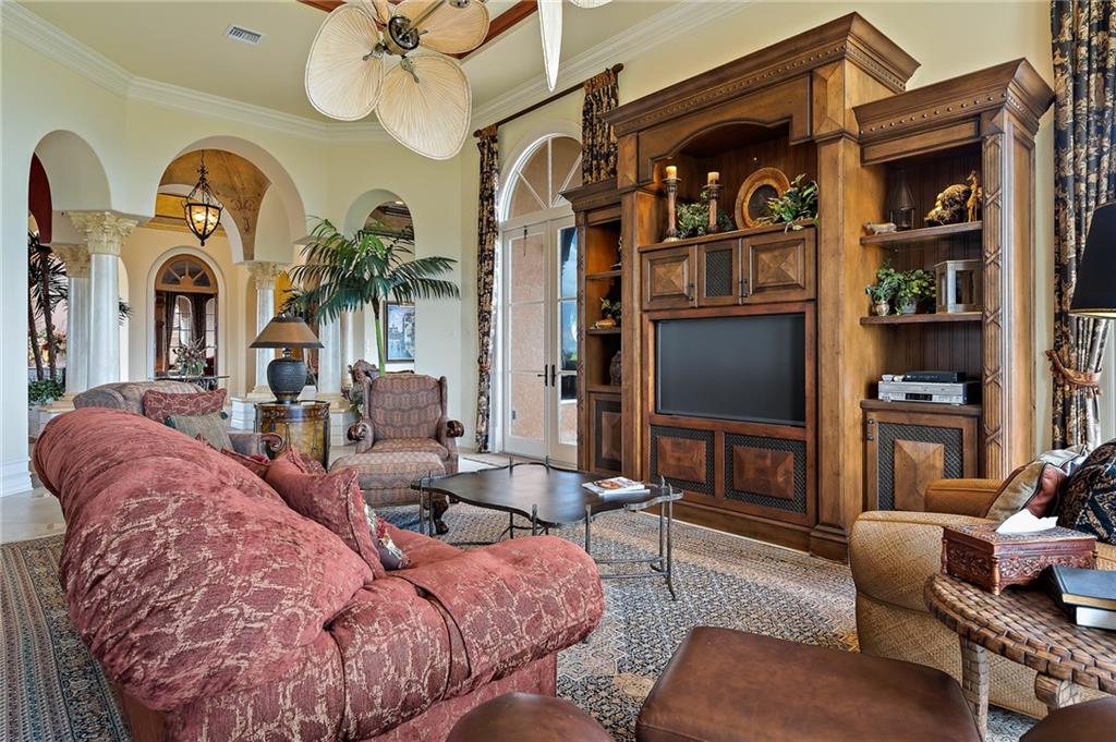 1025 Northeast Doubloon Drive Stuart, FL 34996 - Photo 40 of 69 a living room with fireplace furniture and a flat screen tv