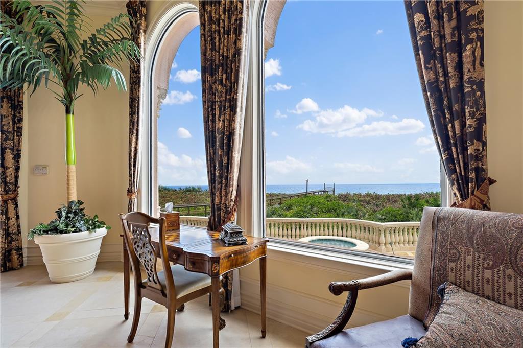 1025 Northeast Doubloon Drive Stuart, FL 34996 - Photo 41 of 69 a view of a chairs and table in patio with a lake view
