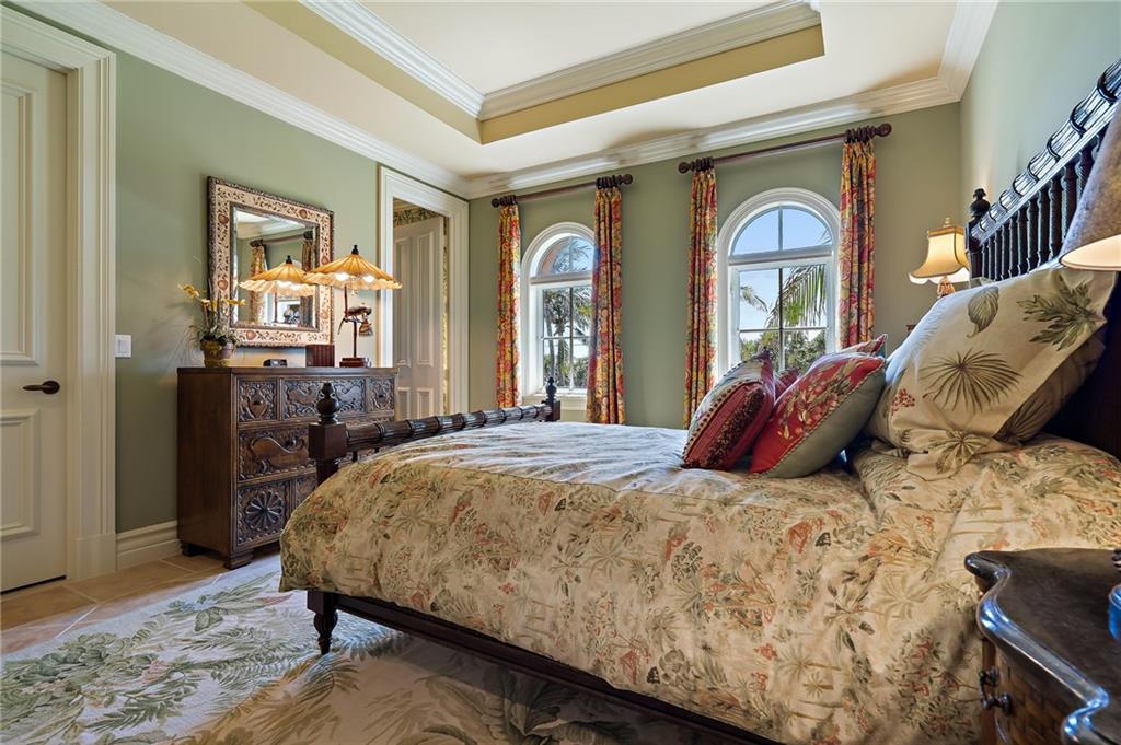 1025 Northeast Doubloon Drive Stuart, FL 34996 - Photo 61 of 69 a bedroom with a large bed and wooden floor