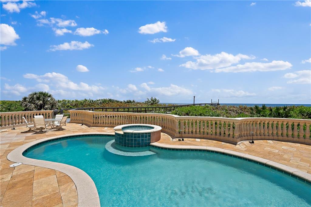 1025 Northeast Doubloon Drive Stuart, FL 34996 - Photo 66 of 69 a view of a swimming pool and lounge chairs in back yard