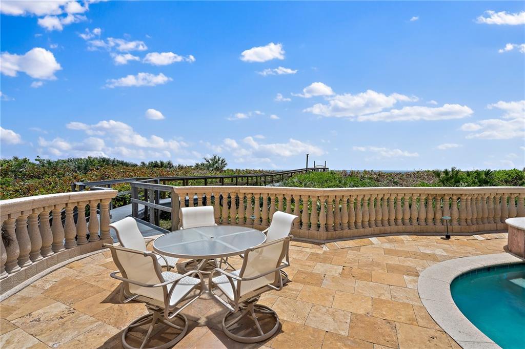 1025 Northeast Doubloon Drive Stuart, FL 34996 - Photo 67 of 69 a view of a chairs and table on the terrace