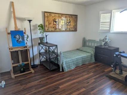 a bedroom with furniture and a window