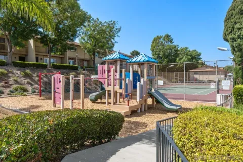 a view of a swimming pool with a patio and a garden