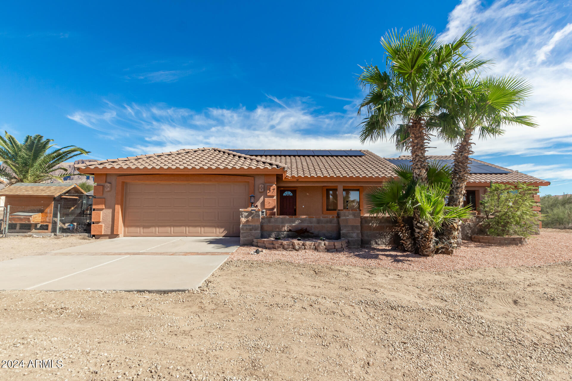 57 North Roadrunner Road Apache Junction, AZ 85119 - Photo 1 of 44 a front view of a house with a yard and garage