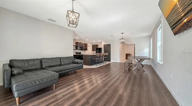 a sign board with a house in the background