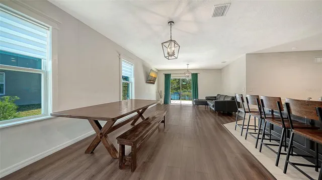 a view of a livingroom with furniture wooden floor and a window