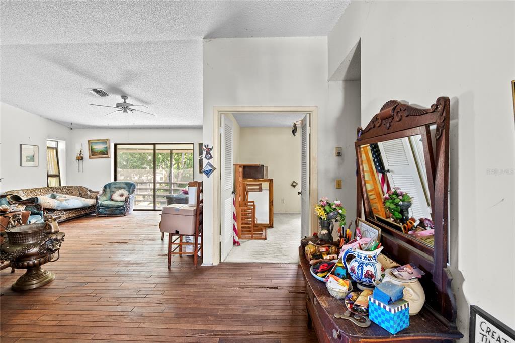 800 Northwest Fork Road, Unit 211 Stuart, FL 34994 - Photo 1 of 1 a living room filled with furniture and a floor to ceiling window