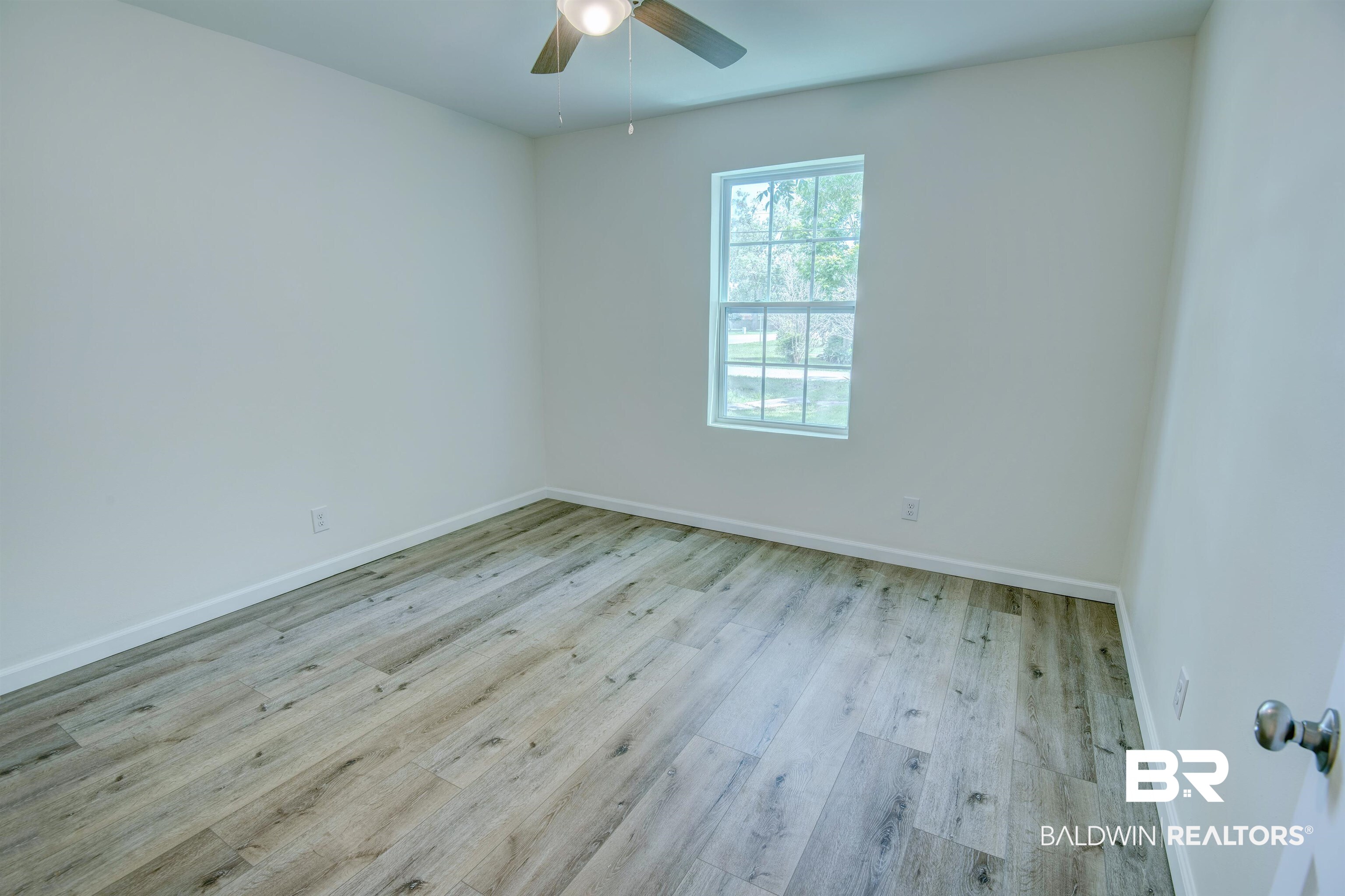 510 East Myrtle Avenue Foley, AL 36535 - Photo 13 of 22 Empty room featuring ceiling fan and wood finished floors