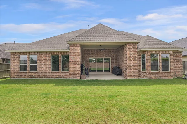 a view of a house with a backyard