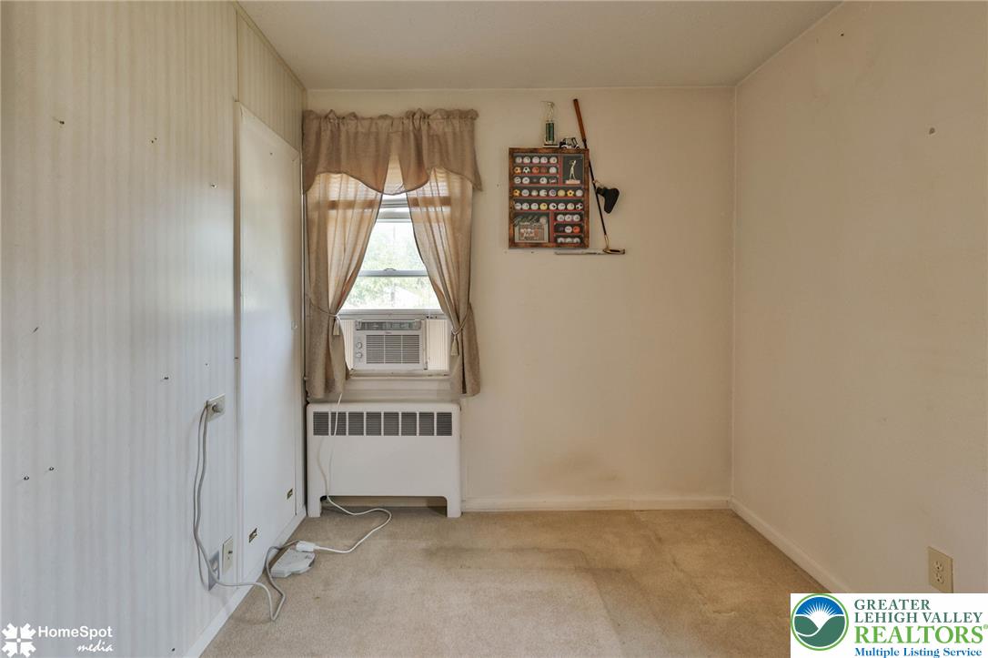 3069 Shakespeare Road Bethlehem, PA 18017 - Photo 18 of 50 A window-mounted air conditioner and baseboard heating unit provide comfort in this carpeted room.