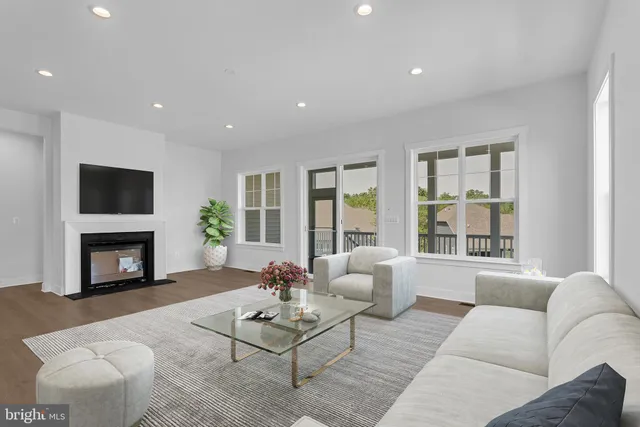 a living room with furniture flat screen tv and a fireplace