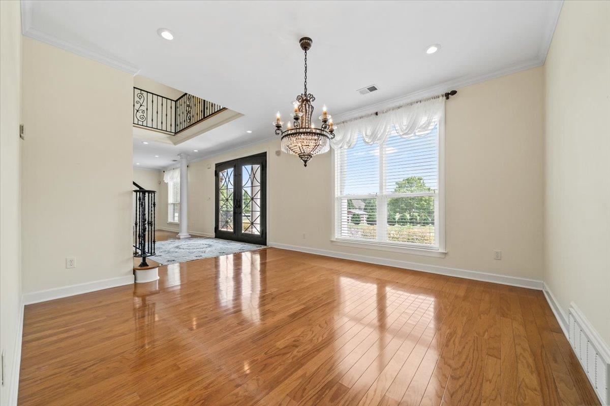 740 Frazier Road Rossville, TN 38066 - Photo 8 of 40 Formal room featuring wood-finish flooring and a central chandelier