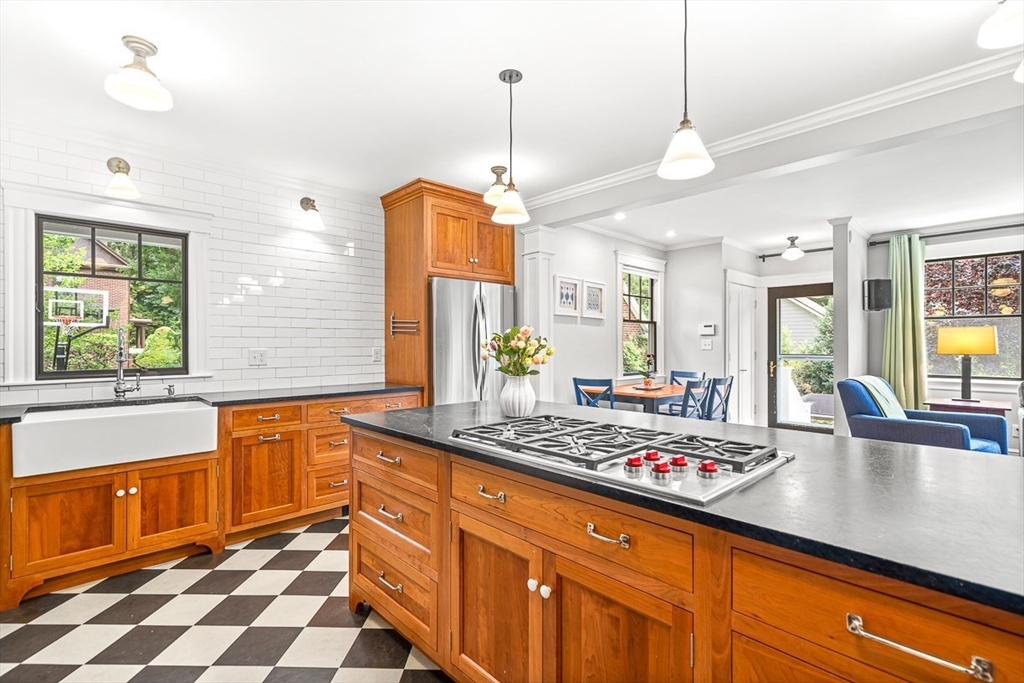 34 Rangeley Road Winchester, MA 01890 - Photo 13 of 42 a kitchen with stainless steel appliances granite countertop a sink a stove and a wooden cabinets