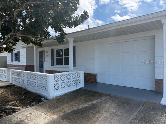 4234 Ridgefield Avenue Holiday, FL 34691 - Photo 1 of 1 a view of backyard with a deck and wooden fence