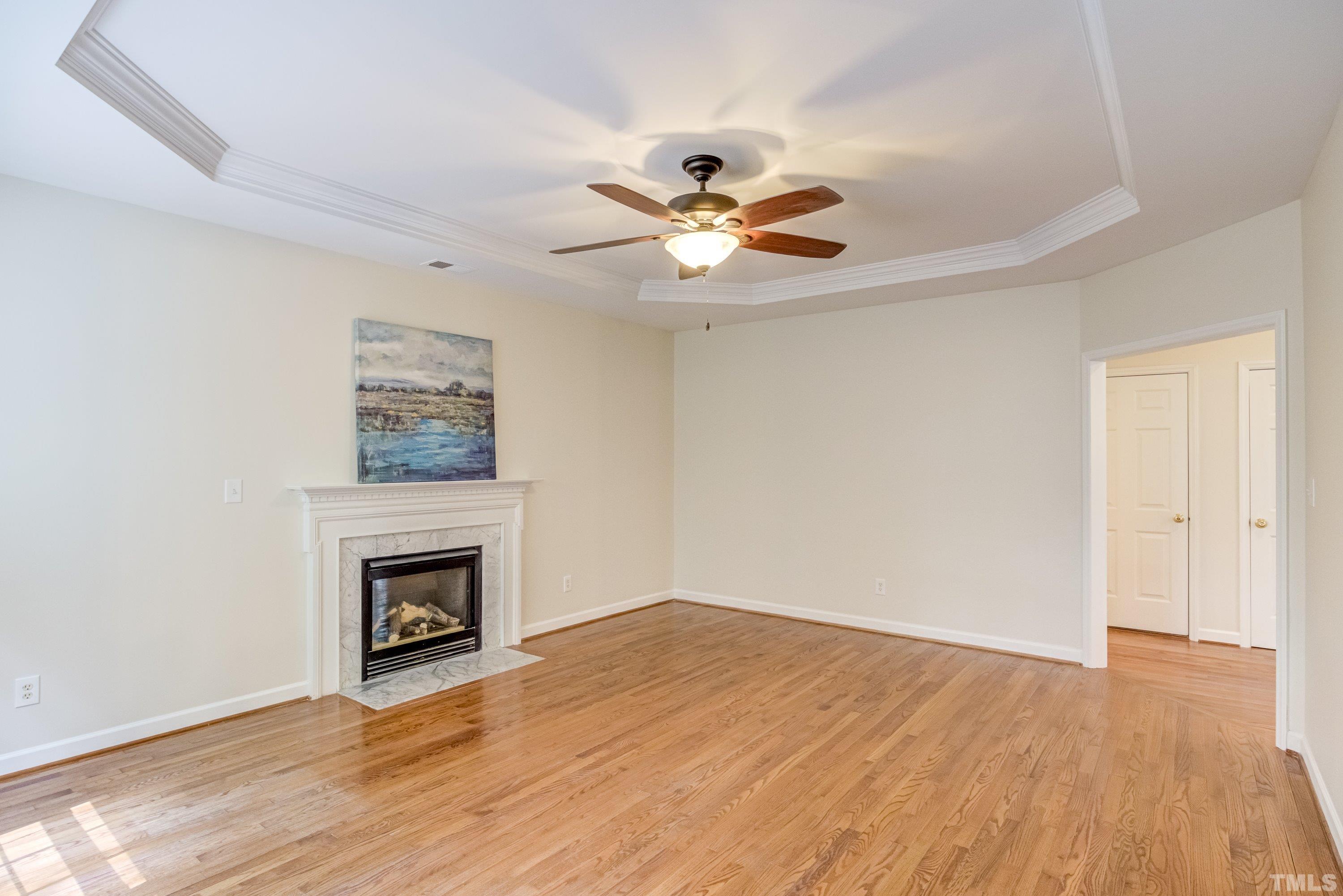 467 Seastone Street Raleigh, NC 27603 - Photo 18 of 38 a view of empty room with wooden floor and fan