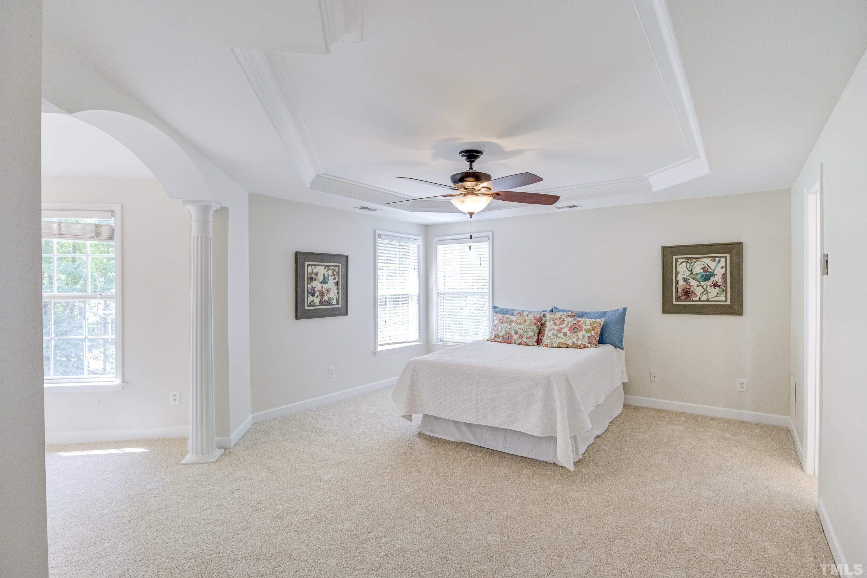 467 Seastone Street Raleigh, NC 27603 - Photo 28 of 38 a bedroom with a bed and a chandelier