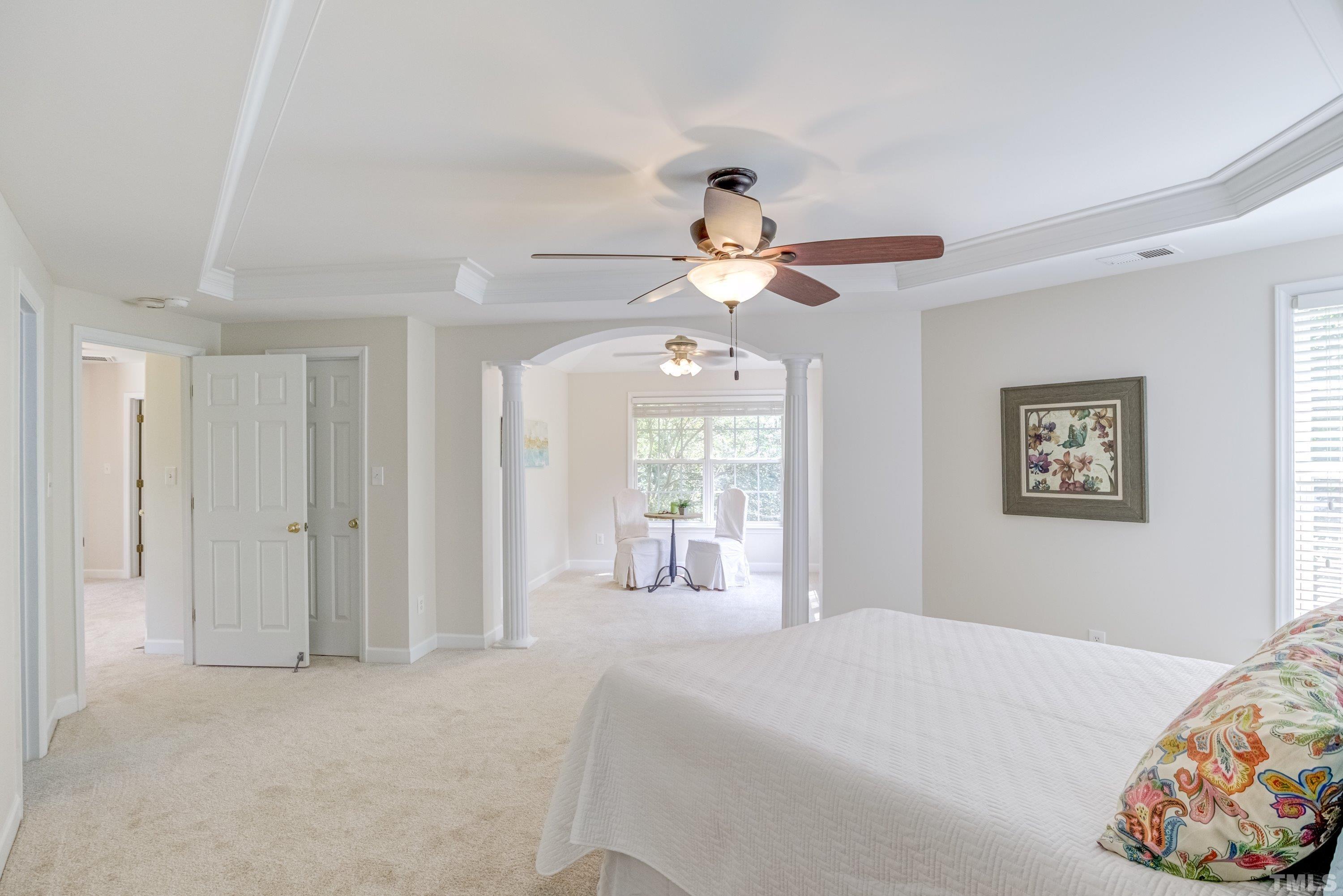 467 Seastone Street Raleigh, NC 27603 - Photo 29 of 38 a bedroom with a large bed and a chandelier