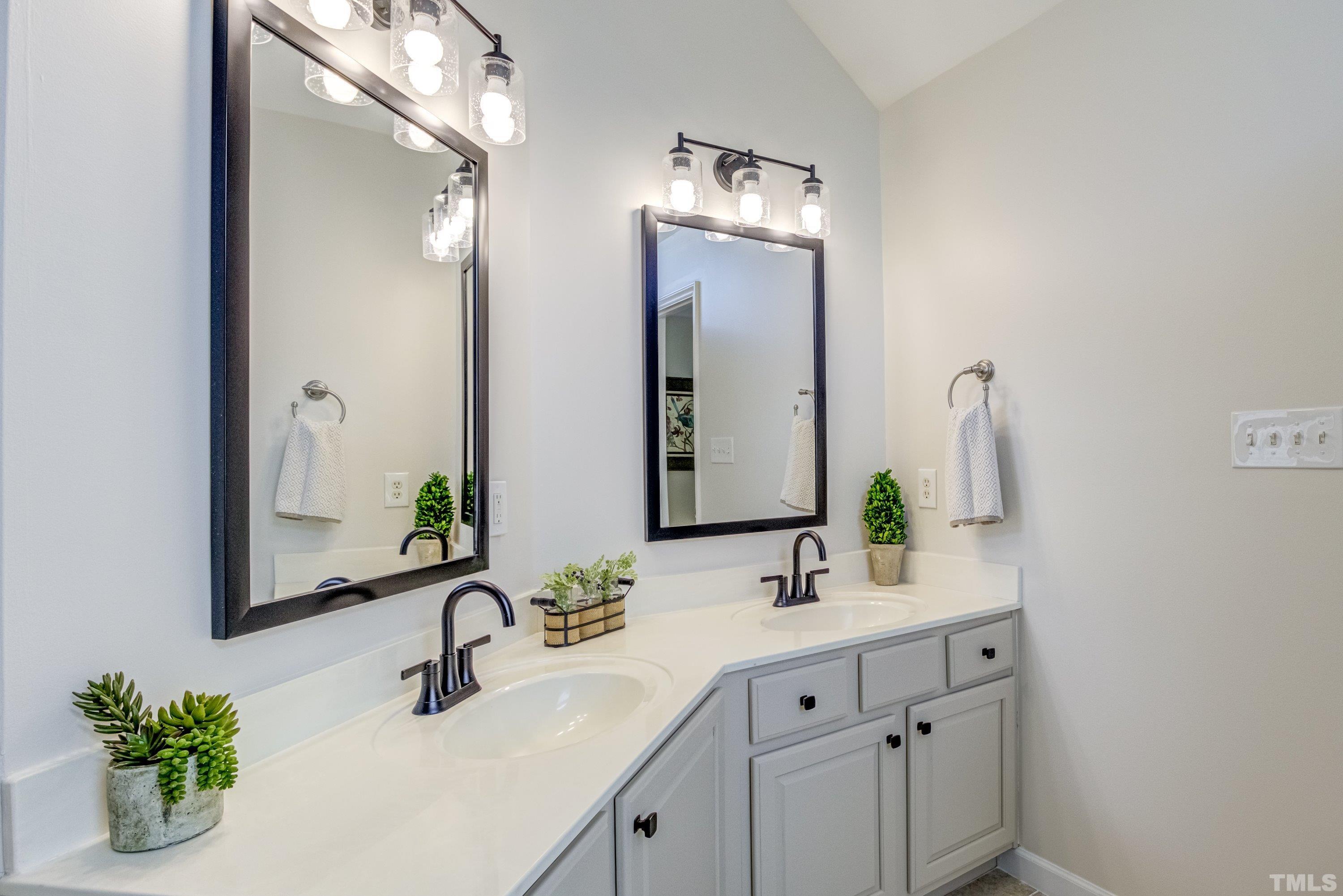 467 Seastone Street Raleigh, NC 27603 - Photo 33 of 38 a bathroom with a sink double vanity and a mirror