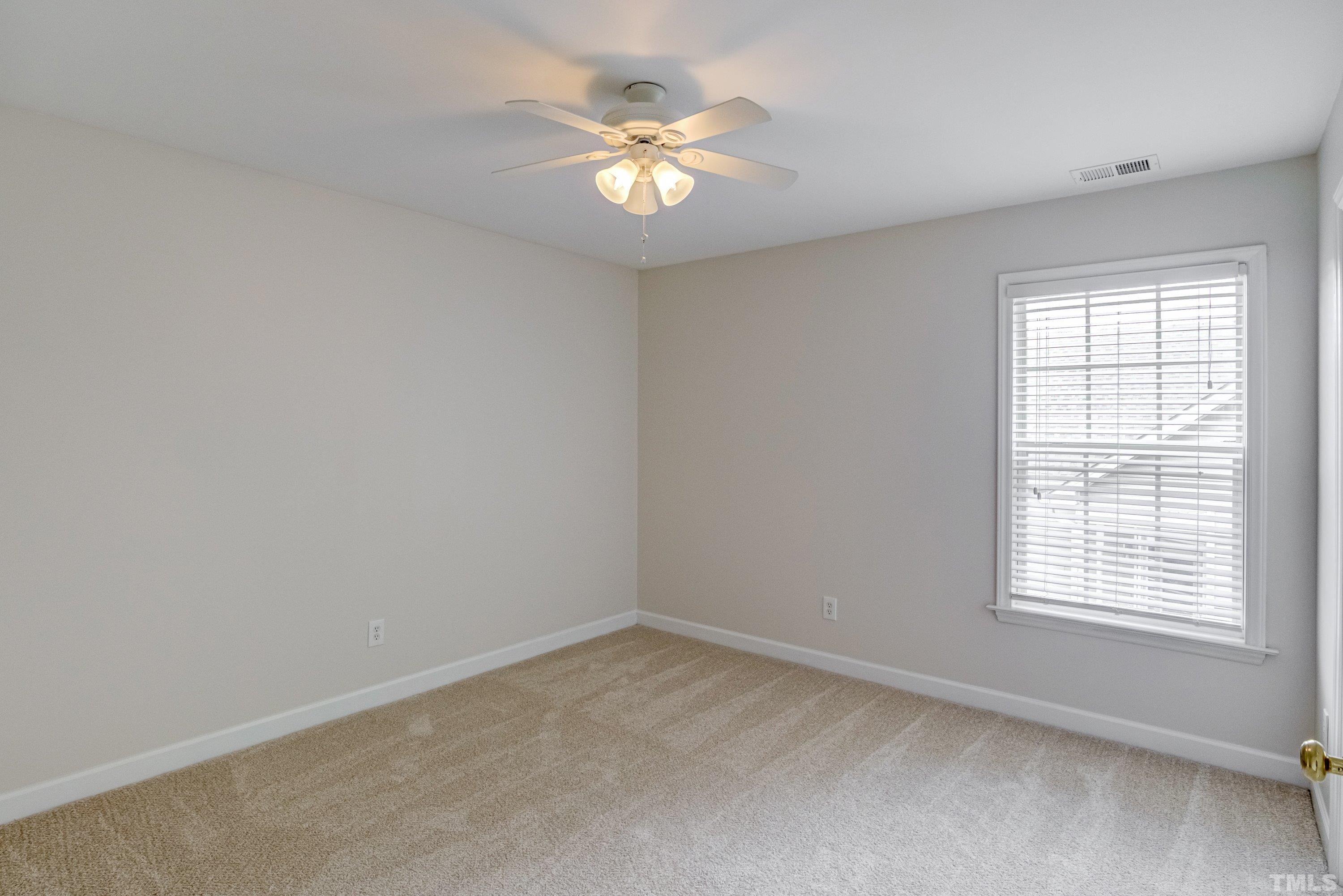467 Seastone Street Raleigh, NC 27603 - Photo 36 of 38 an empty room with a window and a fan