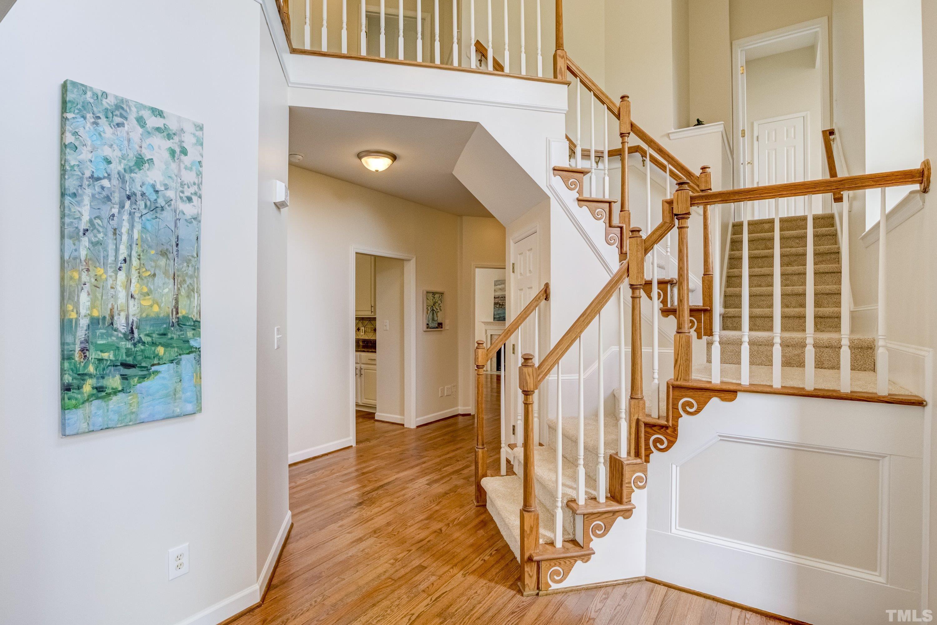 467 Seastone Street Raleigh, NC 27603 - Photo 7 of 38 a view of entryway with wooden floor and stairs