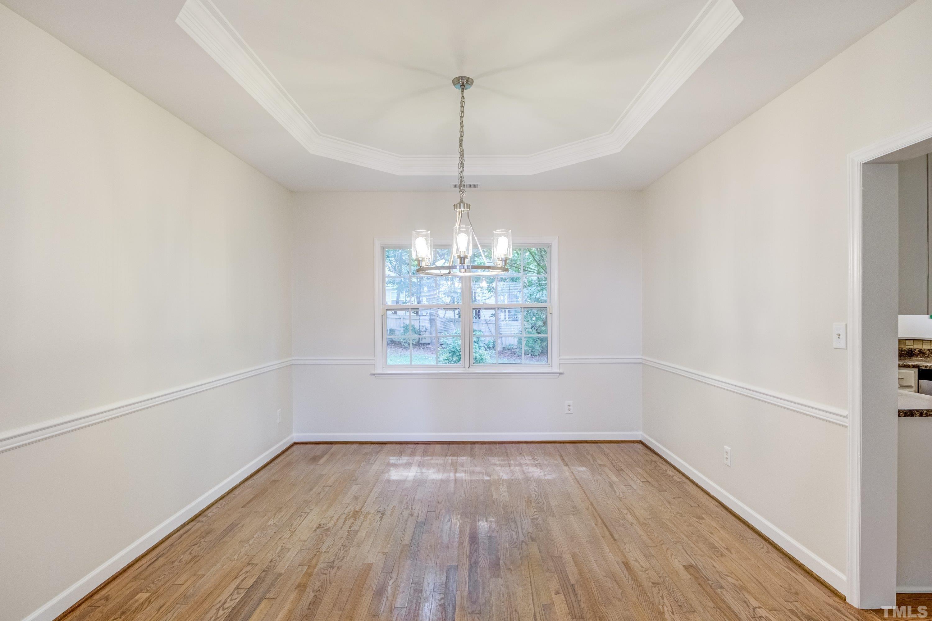 467 Seastone Street Raleigh, NC 27603 - Photo 10 of 38 a view of an empty room with wooden floor and a window
