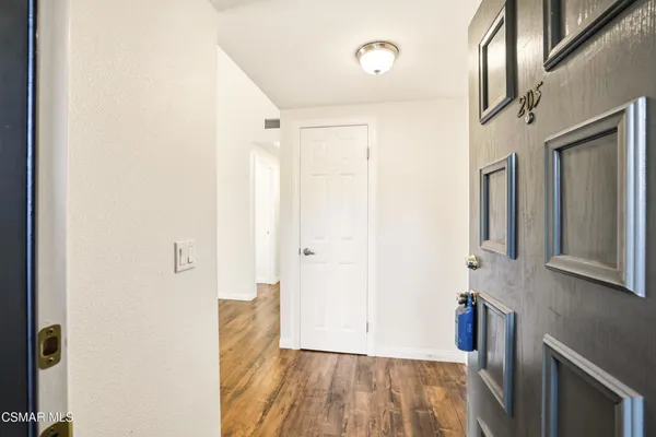 a view of hallway with granite countertop a couch and a stove