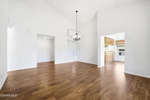 a view of a room with wooden floor ceiling fan
