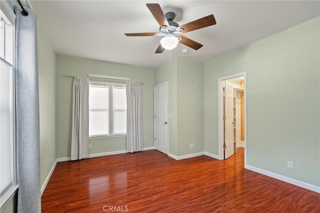 1158 East 7th Street Chico, CA 95928 - Photo 17 of 41 a view of a livingroom with wooden floor and a ceiling fan