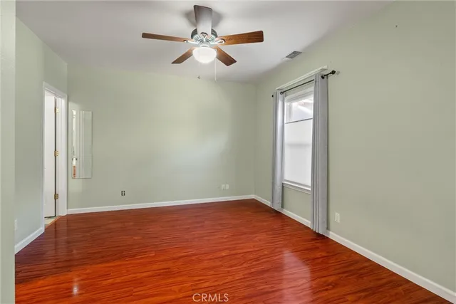 wooden floor in an empty room with a window