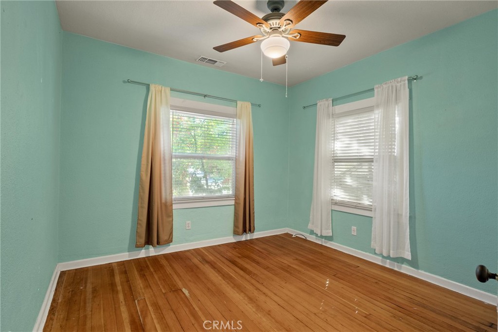 1158 East 7th Street Chico, CA 95928 - Photo 22 of 41 a view of empty room with wooden floor and fan
