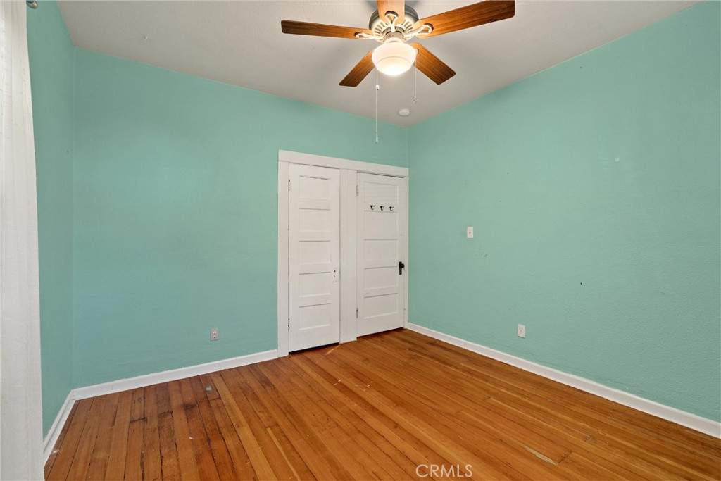 1158 East 7th Street Chico, CA 95928 - Photo 23 of 41 an empty room with a fan and wooden floor