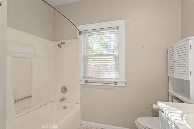 a bathroom with a toilet and a bathtub