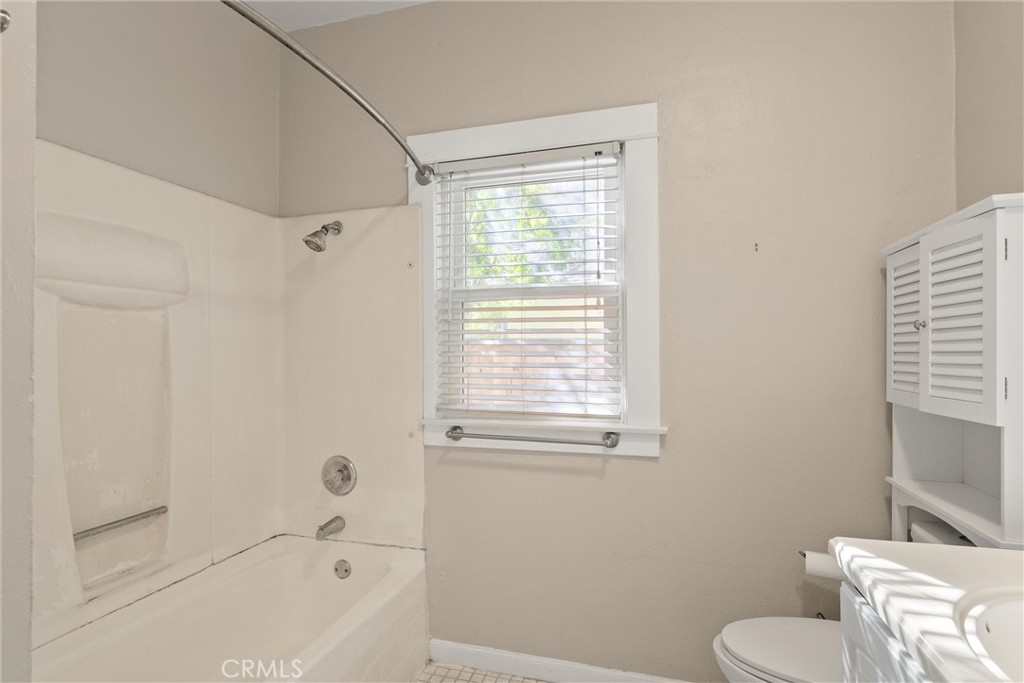 1158 East 7th Street Chico, CA 95928 - Photo 25 of 41 a bathroom with a toilet and a bathtub