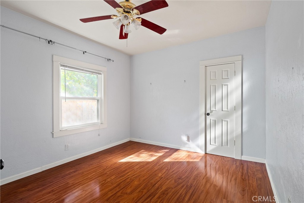 1158 East 7th Street Chico, CA 95928 - Photo 26 of 41 an empty room with wooden floor closet and windows