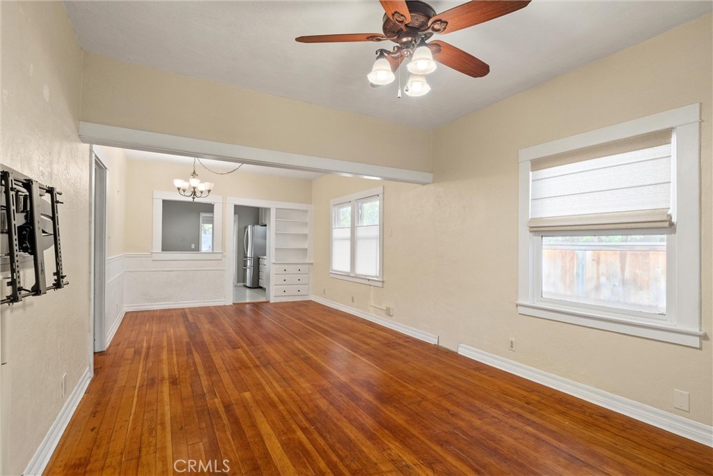 1158 East 7th Street Chico, CA 95928 - Photo 3 of 41 a bedroom with a bed and a chandelier fan