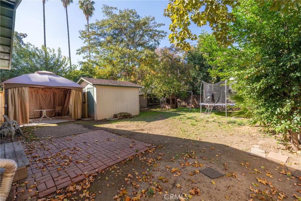 1158 East 7th Street Chico, CA 95928 - Photo 31 of 41 a view of a backyard with large trees and a barn